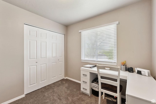 office area with dark carpet and baseboards