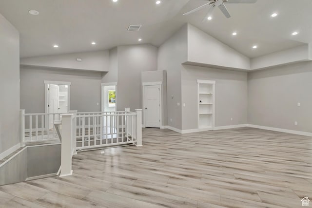 spare room with a ceiling fan, light wood-type flooring, baseboards, recessed lighting, and high vaulted ceiling