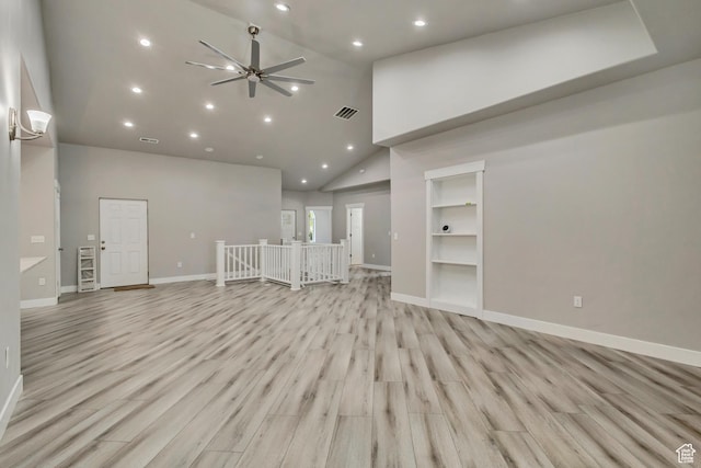 unfurnished living room with high vaulted ceiling, recessed lighting, a ceiling fan, baseboards, and light wood-type flooring