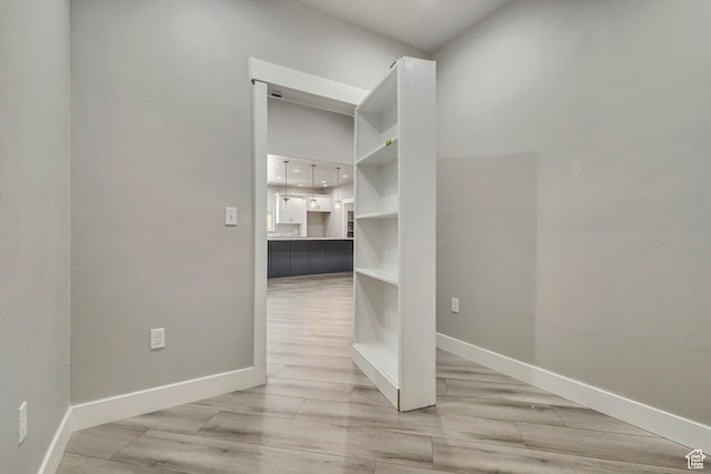 empty room with light wood-style flooring and baseboards