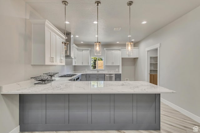 kitchen with a peninsula, baseboards, light stone countertops, dishwasher, and recessed lighting