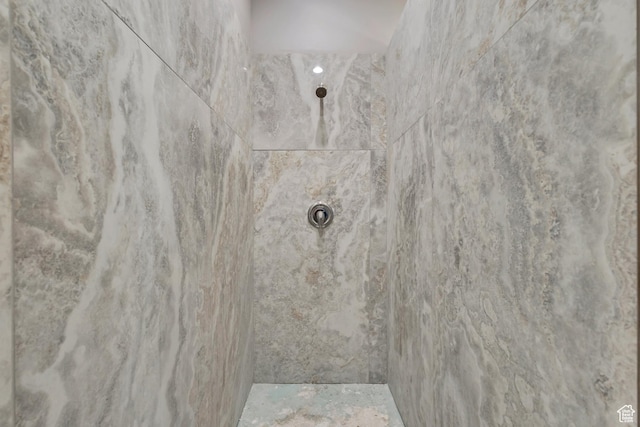 bathroom with a tile shower