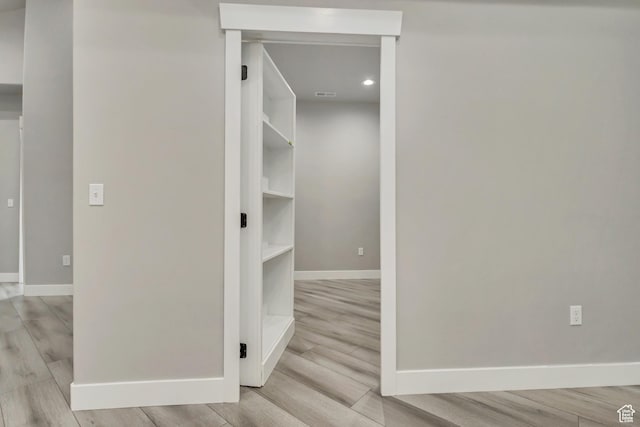 hall with baseboards, wood finished floors, and recessed lighting