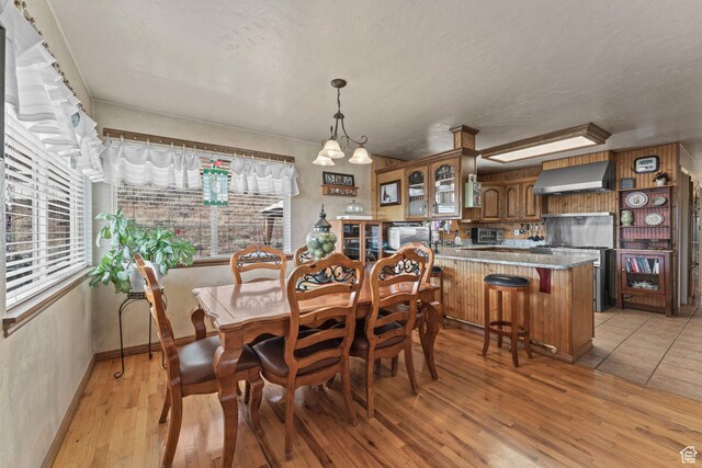 6407 N Dry Fork Cyn W, Dry Fork, UT 84078 - dining room featuring healthy amount of natural light, light wood-style flooring, baseboards, and a textured ceiling