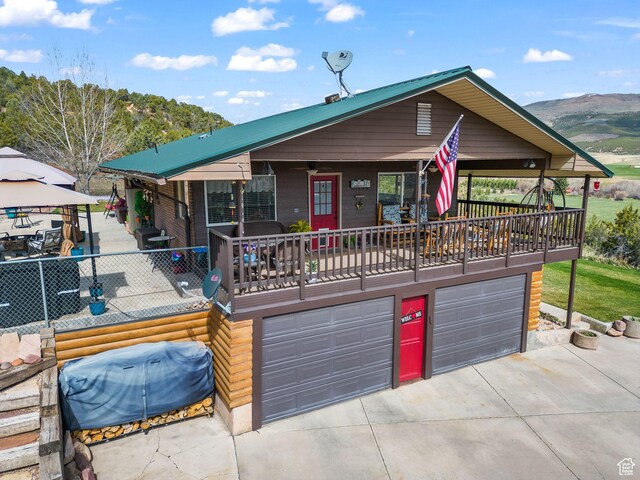 6407 N Dry Fork Cyn W, Dry Fork, UT 84078 - view of front facade featuring concrete driveway, a garage, a gazebo, and a mountain view