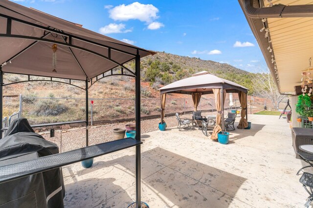 6407 N Dry Fork Cyn W, Dry Fork, UT 84078 - view of patio featuring a gazebo, a mountain view, and fence