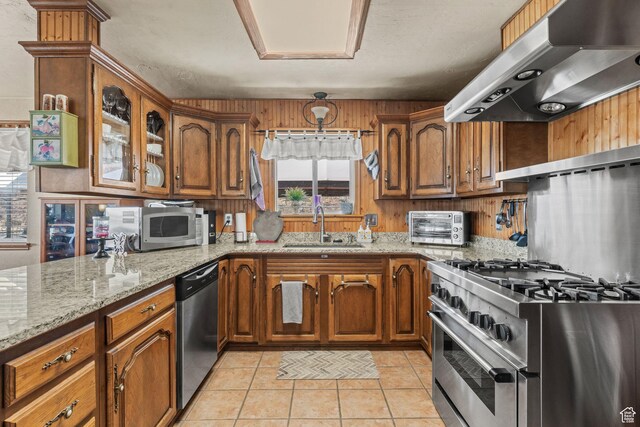 6407 N Dry Fork Cyn W, Dry Fork, UT 84078 - kitchen featuring ventilation hood, stainless steel appliances, a sink, brown cabinetry, and light stone countertops