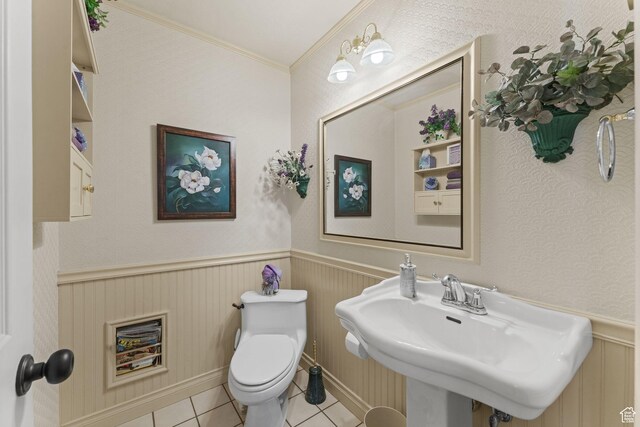 6407 N Dry Fork Cyn W, Dry Fork, UT 84078 - bathroom featuring toilet, tile patterned floors, a wainscoted wall, a sink, and crown molding