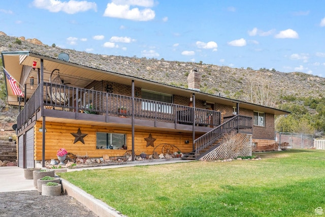 6407 N Dry Fork Cyn W, Dry Fork, UT 84078 - back of house featuring stairway, driveway, an attached garage, a mountain view, and a chimney