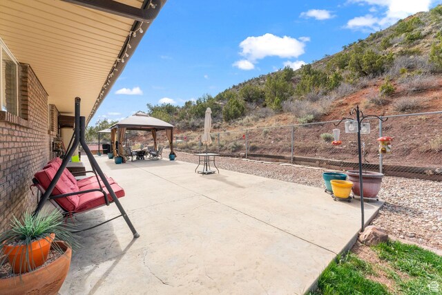 6407 N Dry Fork Cyn W, Dry Fork, UT 84078 - view of patio with a gazebo, fence, and a mountain view