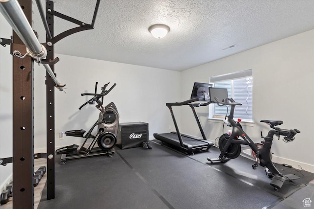 5118 N Blackbrush Dr, Eagle Mountain, UT 84005 - exercise area featuring a textured ceiling and baseboards
