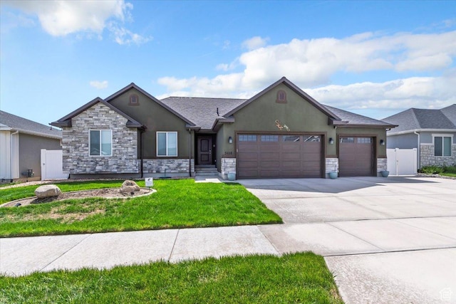 5118 N Blackbrush Dr, Eagle Mountain, UT 84005 - ranch-style home with stucco siding, stone siding, a garage, and concrete driveway