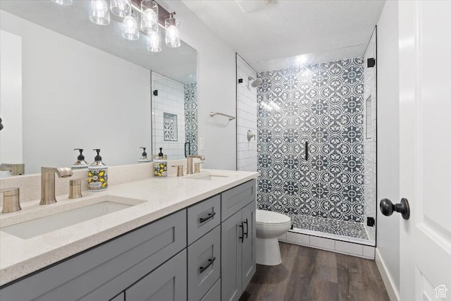 5118 N Blackbrush Dr, Eagle Mountain, UT 84005 - full bath featuring toilet, wood finished floors, a tile shower, and double vanity