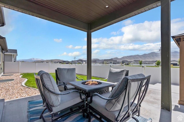 5118 N Blackbrush Dr, Eagle Mountain, UT 84005 - view of patio / terrace with an outdoor fire pit, a fenced backyard, and a mountain view