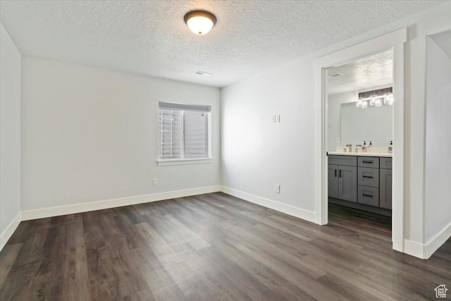5118 N Blackbrush Dr, Eagle Mountain, UT 84005 - unfurnished bedroom featuring dark wood finished floors, a textured ceiling, and baseboards