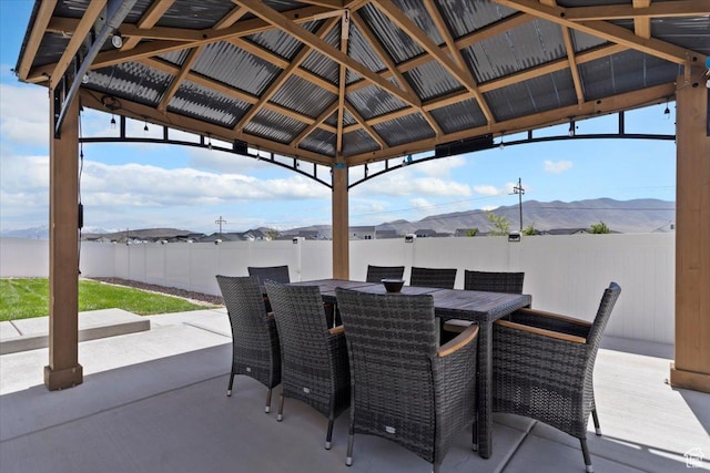 5118 N Blackbrush Dr, Eagle Mountain, UT 84005 - view of patio featuring a fenced backyard, outdoor dining area, a mountain view, and a gazebo