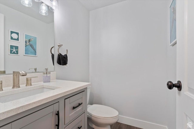 5118 N Blackbrush Dr, Eagle Mountain, UT 84005 - bathroom featuring vanity, toilet, baseboards, and wood finished floors