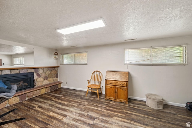 648 S 1350 E, Provo, UT 84606 - sitting room with dark wood finished floors, a textured ceiling, and a stone fireplace