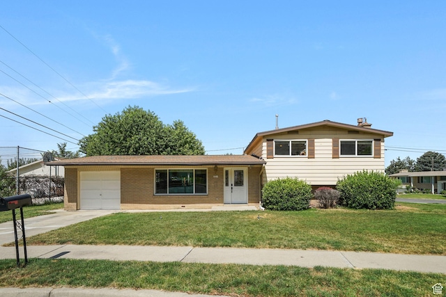648 S 1350 E, Provo, UT 84606 - split level home with an attached garage, brick siding, driveway, and a front yard