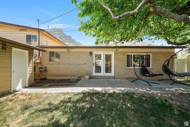 648 S 1350 E, Provo, UT 84606 - back of property featuring a patio, brick siding, and a lawn