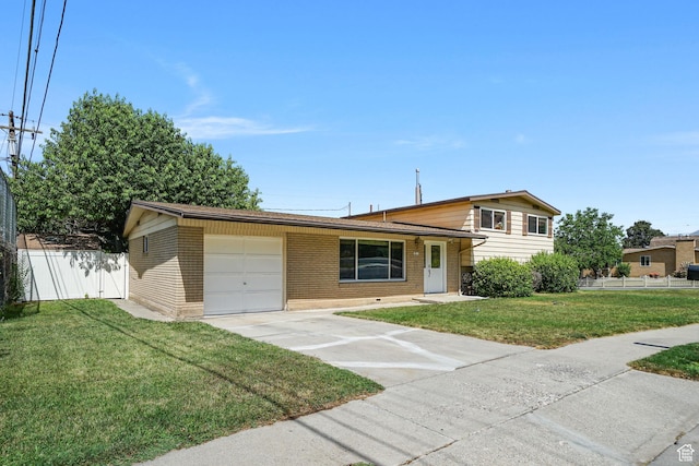 648 S 1350 E, Provo, UT 84606 - split level home featuring an attached garage, brick siding, and concrete driveway