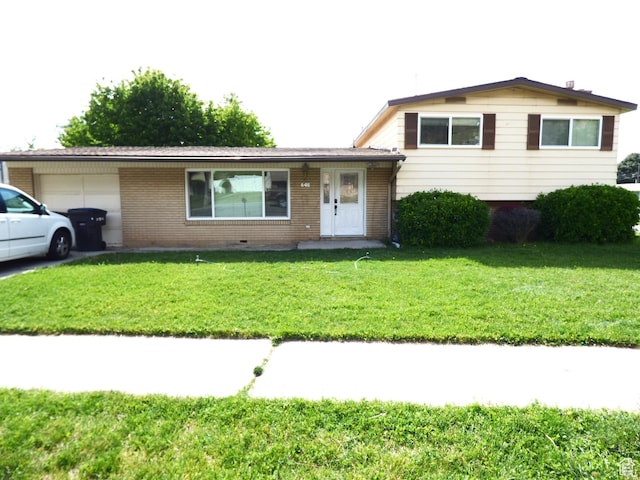 648 S 1350 E, Provo, UT 84606 - split level home with an attached garage, brick siding, and a front yard