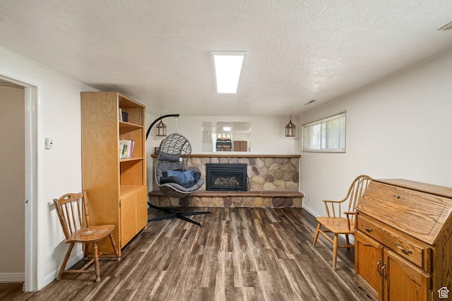 648 S 1350 E, Provo, UT 84606 - sitting room with dark wood-style floors, a stone fireplace, and a textured ceiling