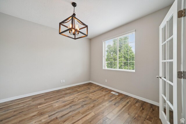 1805 W Grays Pl N, Lehi, UT 84043 - unfurnished room with a chandelier, hardwood / wood-style flooring, and baseboards