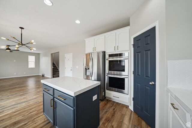 1805 W Grays Pl N, Lehi, UT 84043 - kitchen featuring appliances with stainless steel finishes, a chandelier, white cabinets, dark wood-style floors, and a kitchen island