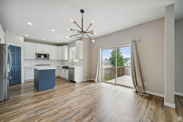 1805 W Grays Pl N, Lehi, UT 84043 - kitchen with appliances with stainless steel finishes, a chandelier, white cabinets, light wood-style flooring, and recessed lighting
