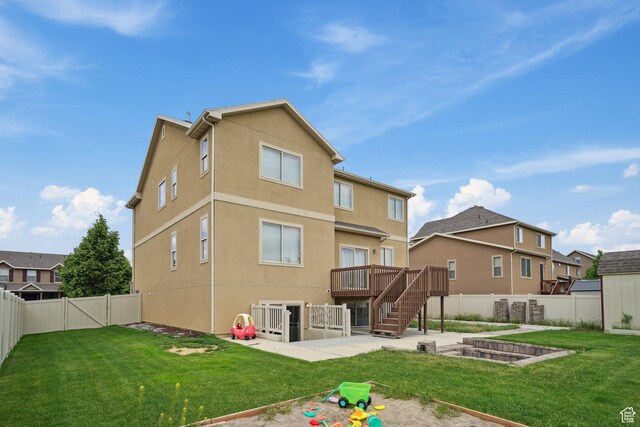 1805 W Grays Pl N, Lehi, UT 84043 - back of house featuring a patio, stucco siding, a vegetable garden, and a wooden deck