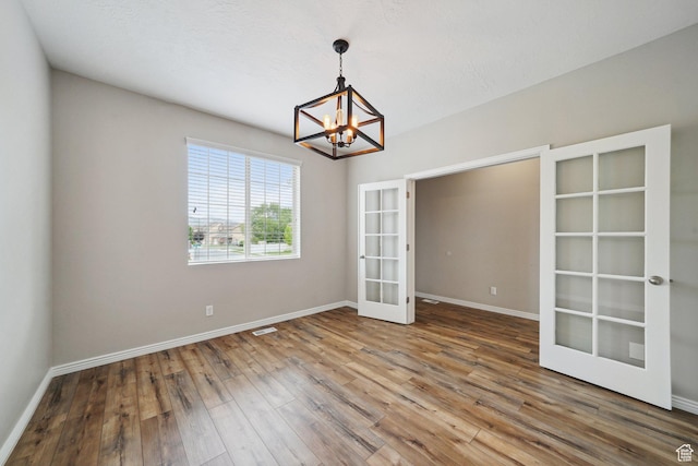 1805 W Grays Pl N, Lehi, UT 84043 - unfurnished room featuring french doors, a chandelier, hardwood / wood-style floors, and baseboards