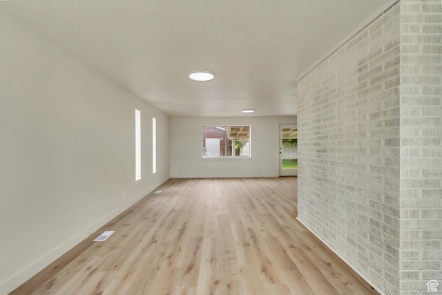 empty room featuring light wood-style floors and baseboards