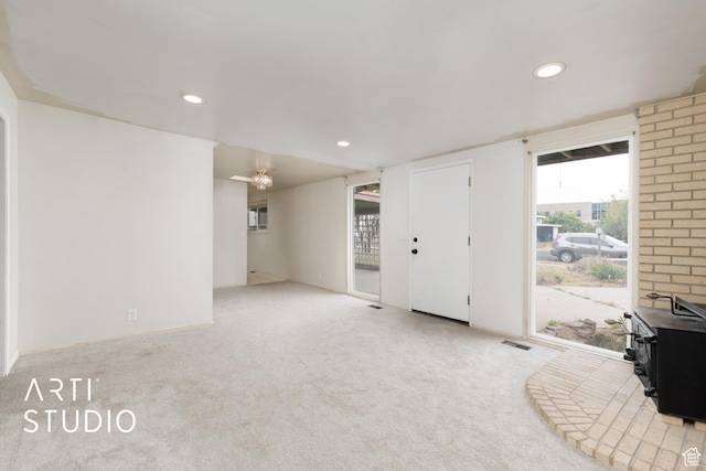 941 E Carnation Dr, Sandy, UT 84094 - unfurnished living room with a wood stove, carpet floors, and recessed lighting