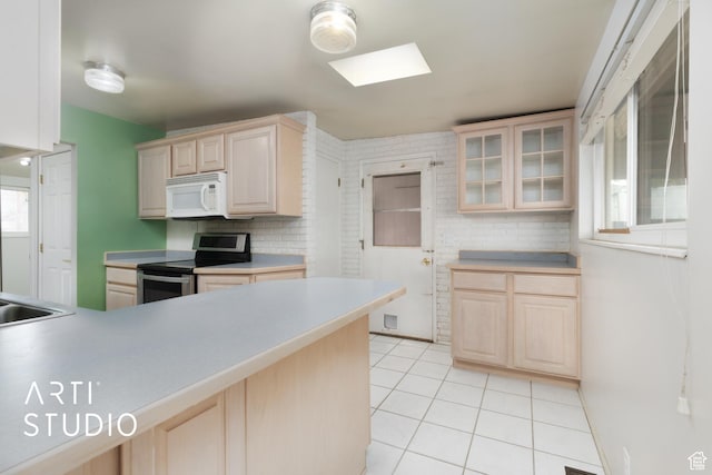 941 E Carnation Dr, Sandy, UT 84094 - kitchen featuring electric range, white microwave, light brown cabinets, and light tile patterned floors