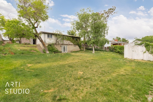941 E Carnation Dr, Sandy, UT 84094 - view of grassy yard featuring a storage shed and an outdoor structure