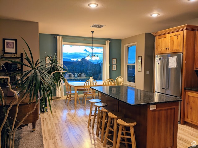 465 N 100th St E, Millville, UT 84326 - kitchen with high end refrigerator, light wood-style flooring, a kitchen breakfast bar, a chandelier, and a kitchen island