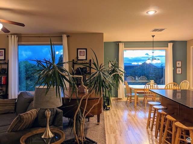 465 N 100th St E, Millville, UT 84326 - dining space featuring light wood-style flooring, a ceiling fan, a chandelier, and recessed lighting