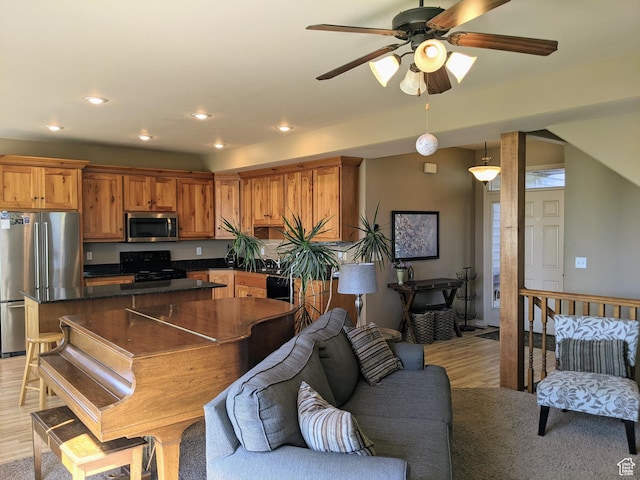 465 N 100th St E, Millville, UT 84326 - kitchen with appliances with stainless steel finishes, light wood-type flooring, open floor plan, dark countertops, and a center island