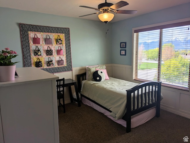 465 N 100th St E, Millville, UT 84326 - carpeted bedroom featuring wainscoting, ceiling fan, and a decorative wall