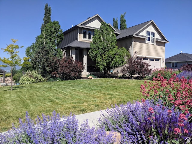 465 N 100th St E, Millville, UT 84326 - view of front of house featuring a front lawn and an attached garage