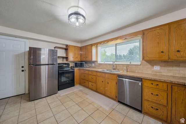 1885 W 300 N, West Point, UT 84015 - kitchen featuring stainless steel appliances, a sink, open shelves, brown cabinetry, and a textured ceiling