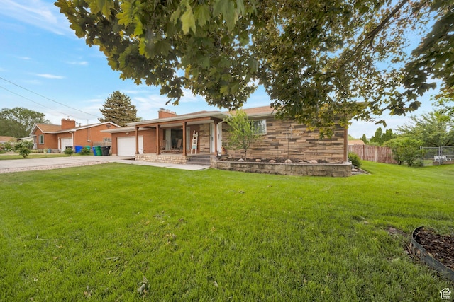 1885 W 300 N, West Point, UT 84015 - view of front of home featuring driveway, an attached garage, stone siding, a chimney, and a porch