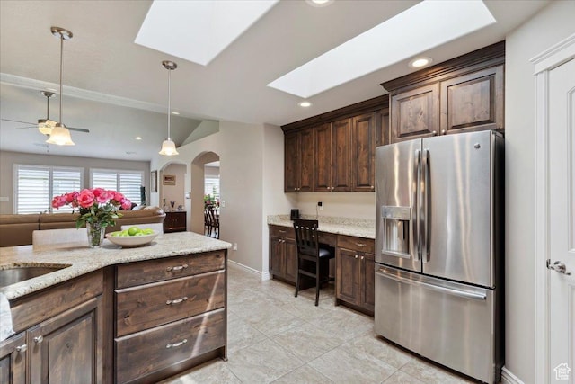 1776 W 3025 S, Syracuse, UT 84075 - kitchen featuring stainless steel fridge with ice dispenser, arched walkways, a skylight, plenty of natural light, and recessed lighting