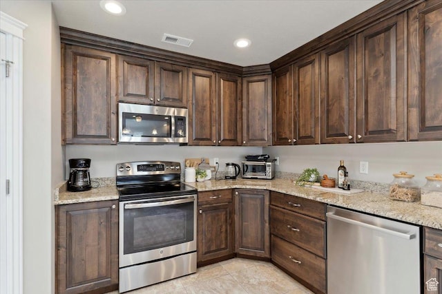 1776 W 3025 S, Syracuse, UT 84075 - kitchen featuring stainless steel appliances, dark brown cabinetry, light tile patterned floors, light stone counters, and recessed lighting