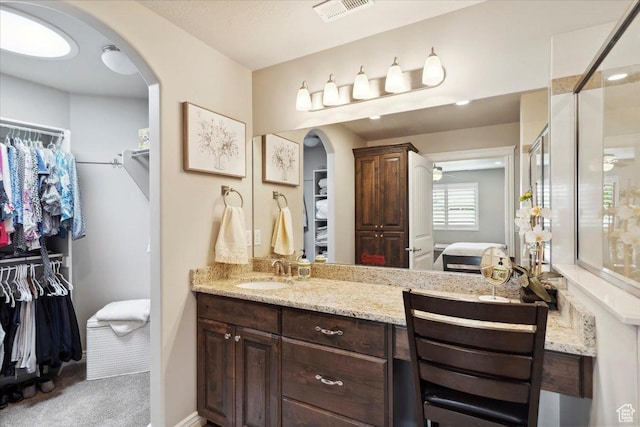 1776 W 3025 S, Syracuse, UT 84075 - full bathroom featuring connected bathroom, a walk in closet, a stall shower, vanity, and ceiling fan