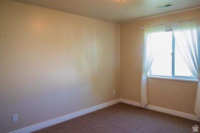 spare room with carpet floors and baseboards