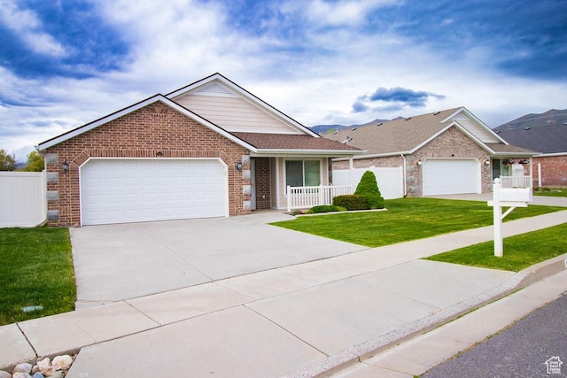ranch-style house with brick siding, an attached garage, driveway, and covered porch