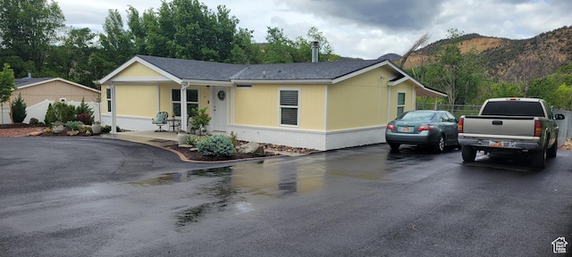 65 E 200 S, Orderville, UT 84758 - view of front of house with brick siding, a mountain view, covered porch, and asphalt driveway