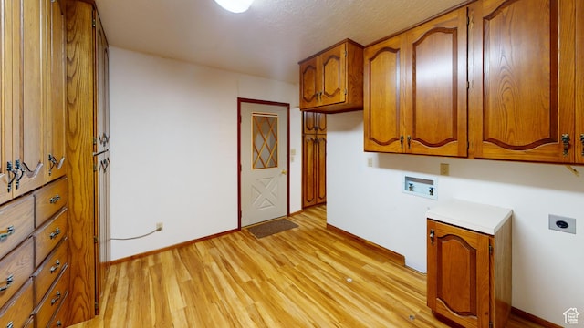 662 N 1600 E, Preston, ID 83263 - washroom featuring hookup for a washing machine, hookup for an electric dryer, cabinet space, light wood-style floors, and baseboards